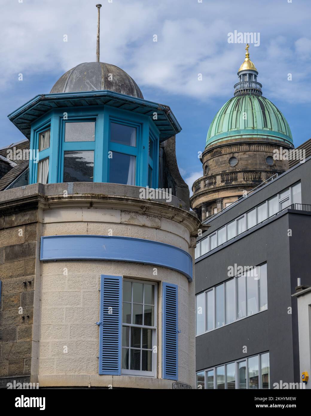The ornate cupola of a building in Queensferry St, Edinburgh, contrasts with Robert Reid's 1811 copper domed St George's Church in Charlotte Square Stock Photo