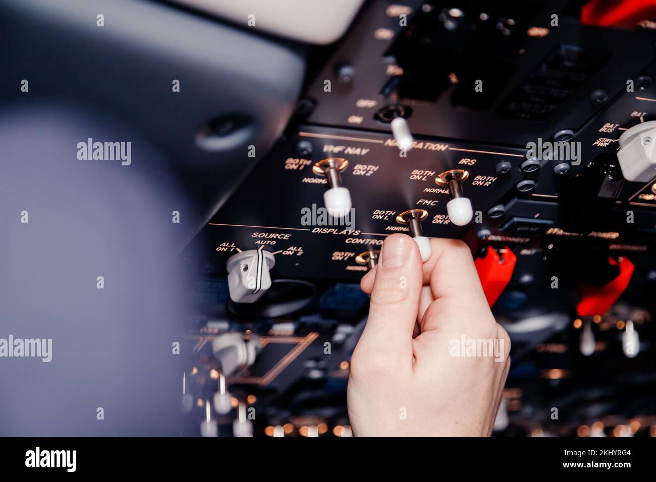 Pilot hand is controlling plane toggle switches to fly take off and