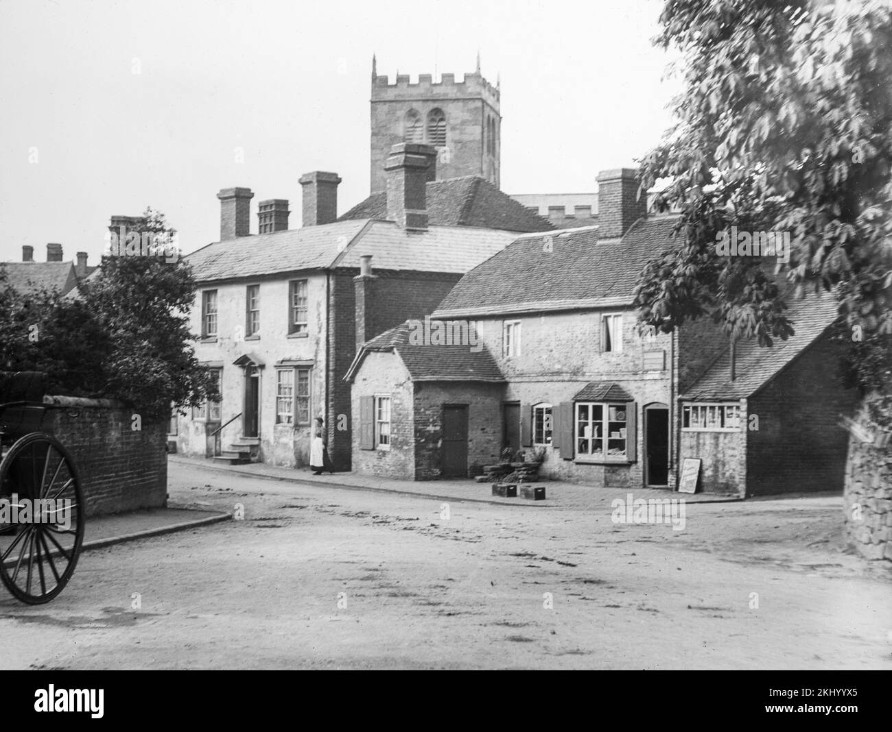 A late 19th century black and white photograph showing a rural English village with its shop and church. Stock Photo