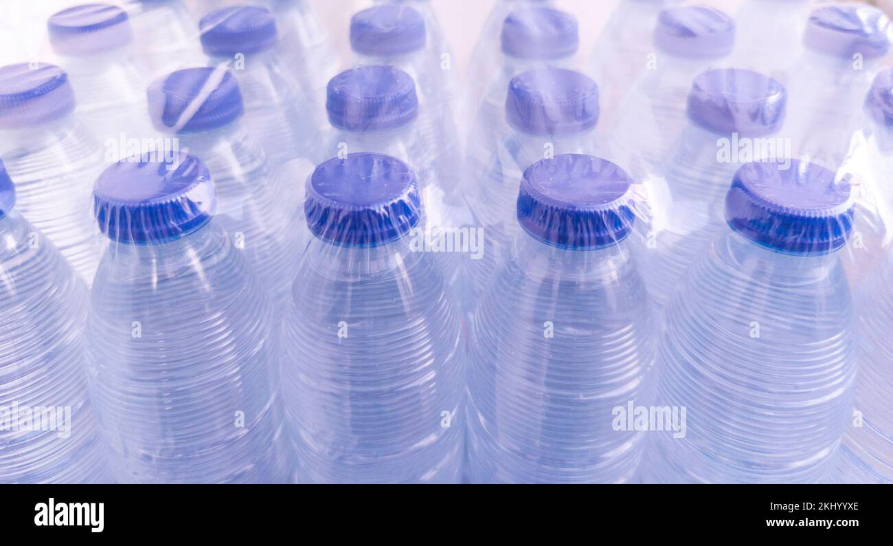 Pack of small shrink-wrapped water bottles. Plastic water bottle pollution concept Stock Photo