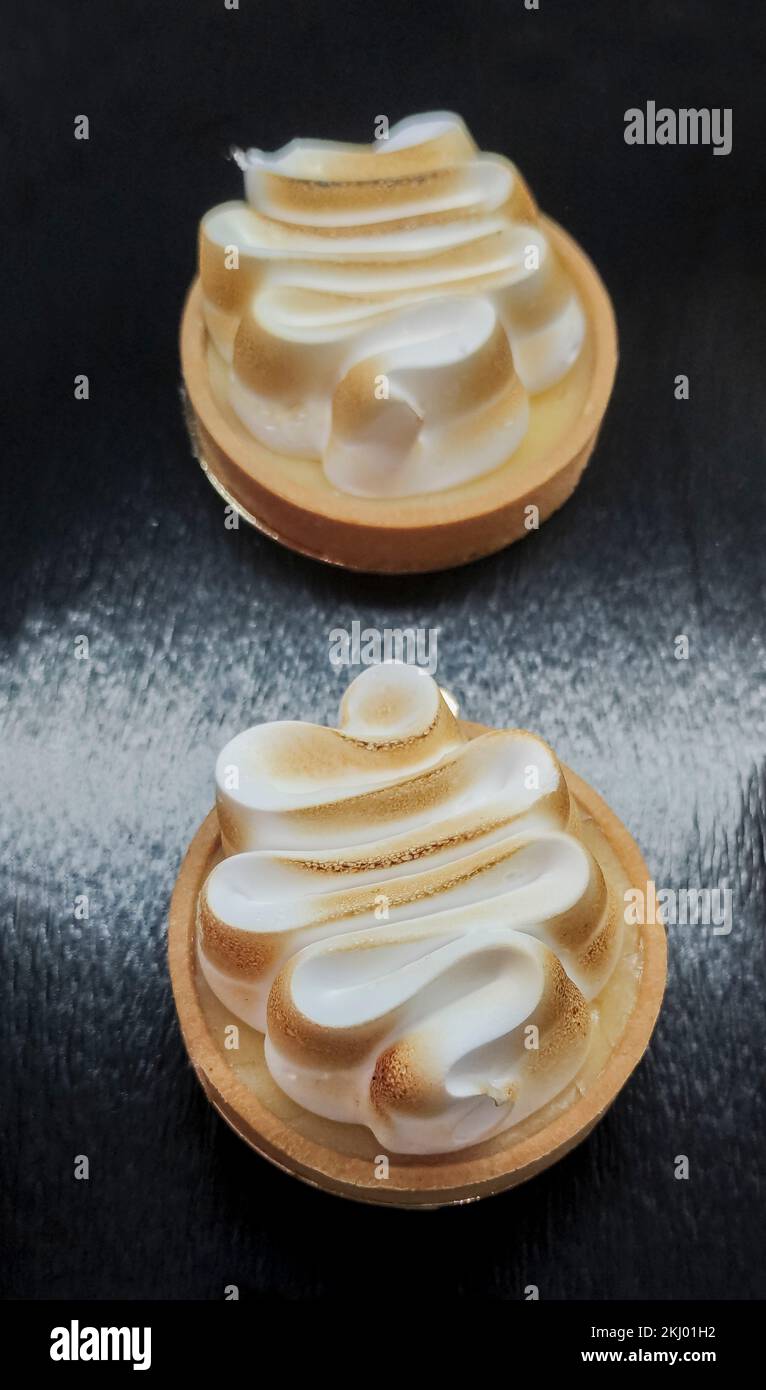 Lemon meringue pie over dark wooden background. Selective focus Stock Photo