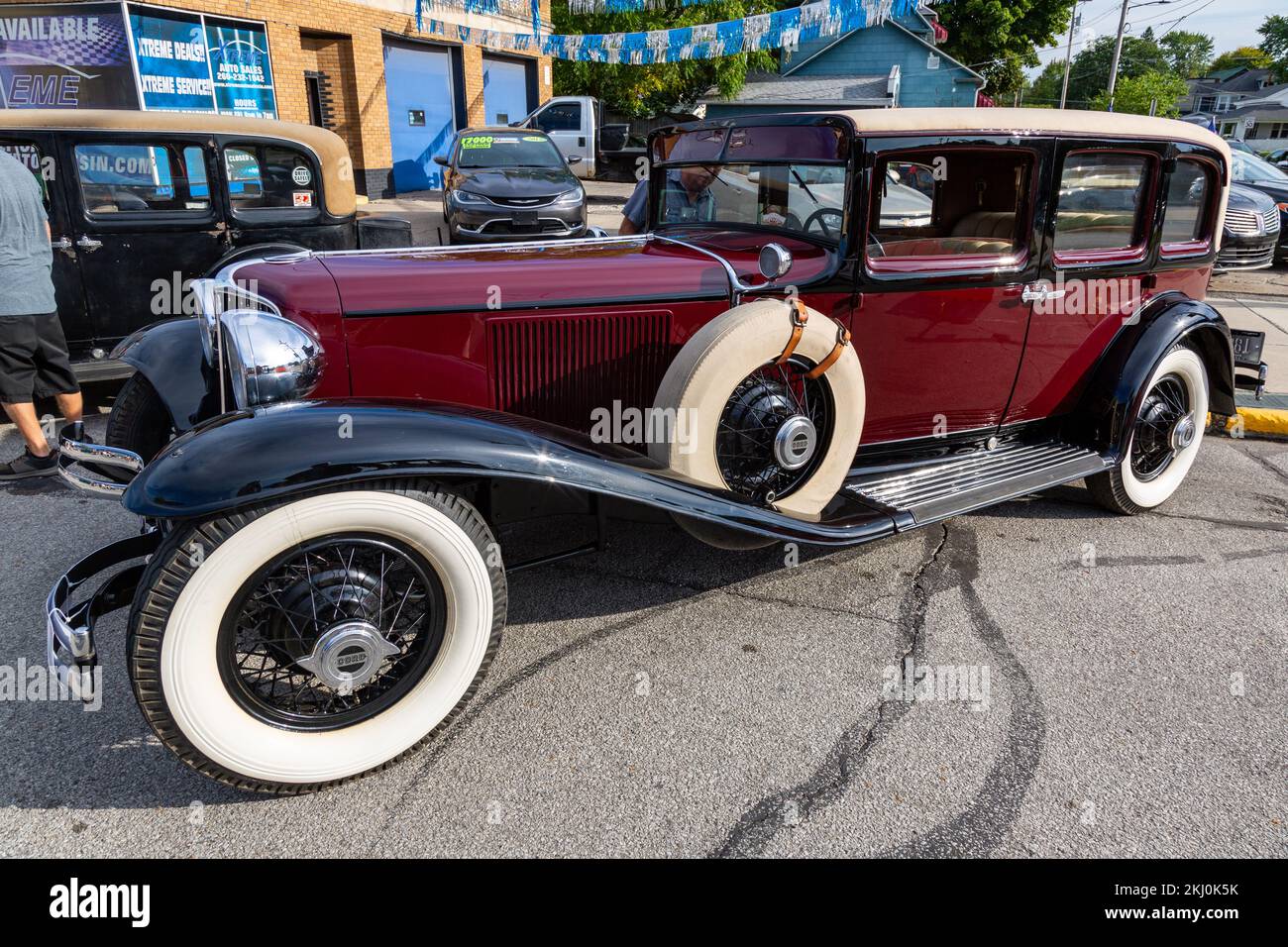 An antique maroon Cord L-29 sedan with suicide doors is on display at a car show in Auburn, Indiana, USA. Stock Photo