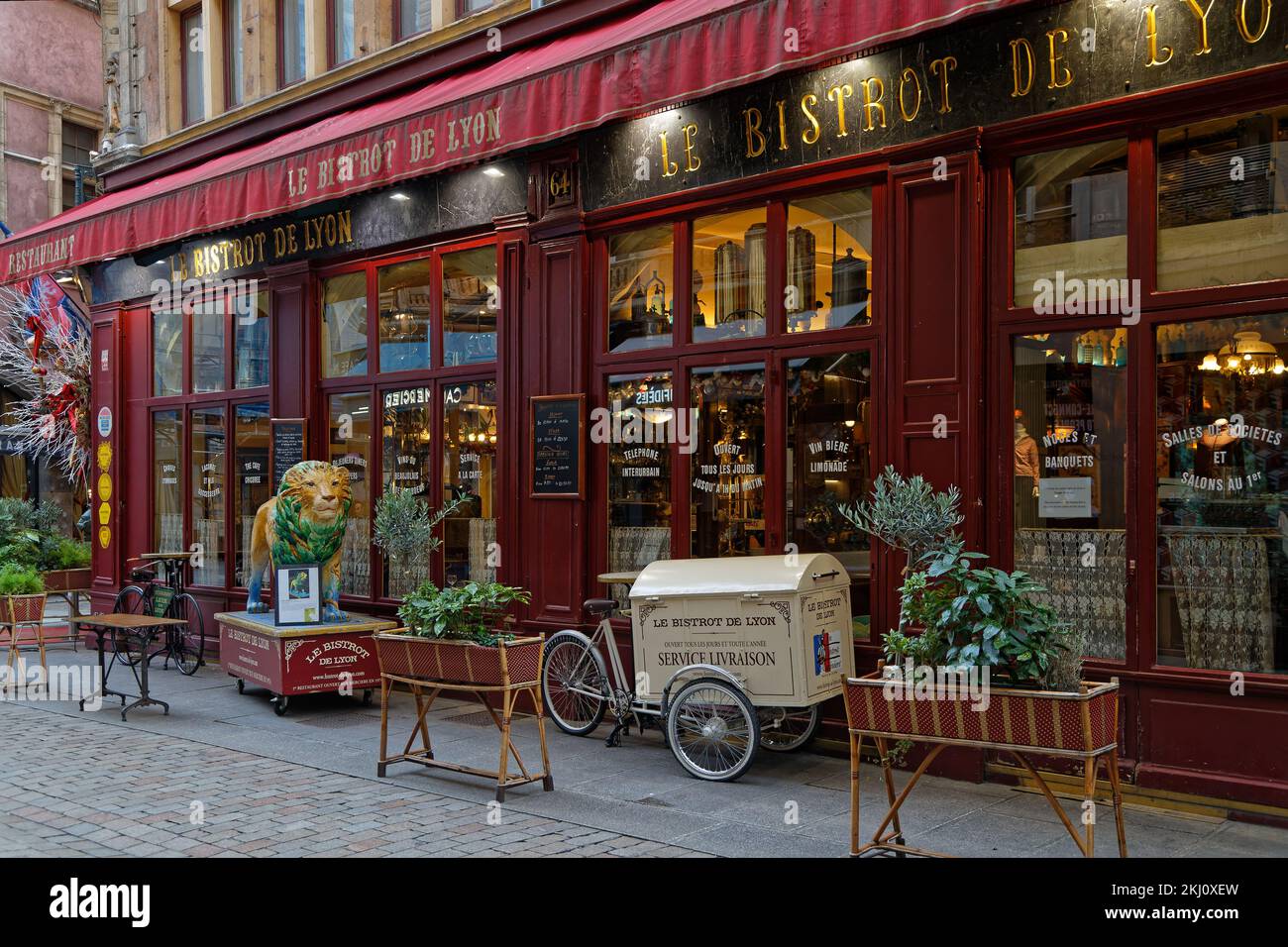 LYON, FRANCE, February 19, 2022 : A traditional bouchon restaurant in a small street. A bouchon is a restaurant found in Lyon that serves traditional Stock Photo