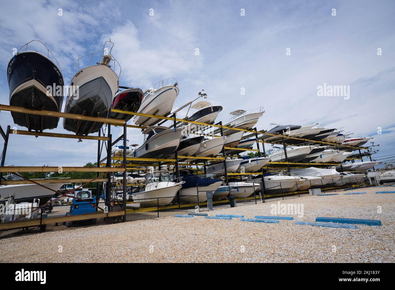 Lots of boats in the outdoor storage under a cloudy sky Stock Photo