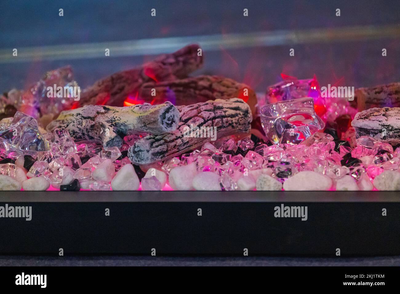 Pink Electric Fireplace With Logs Crystals Pebbles and Diamonds Flame  Effect Stock Photo - Alamy