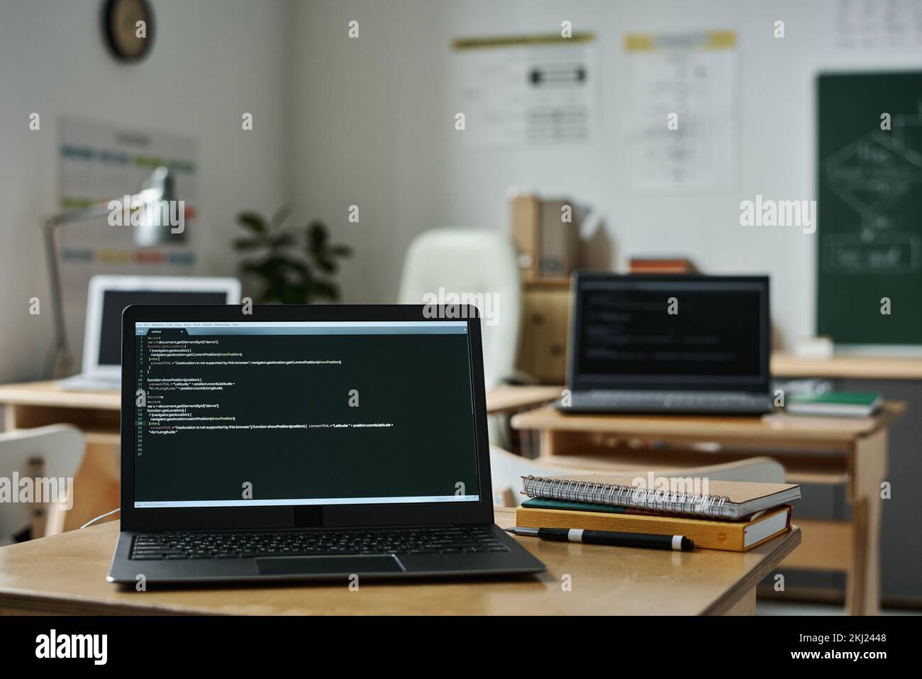 Close-up of laptop on desk with new software on screen in classroom to study IT technology Stock Photo