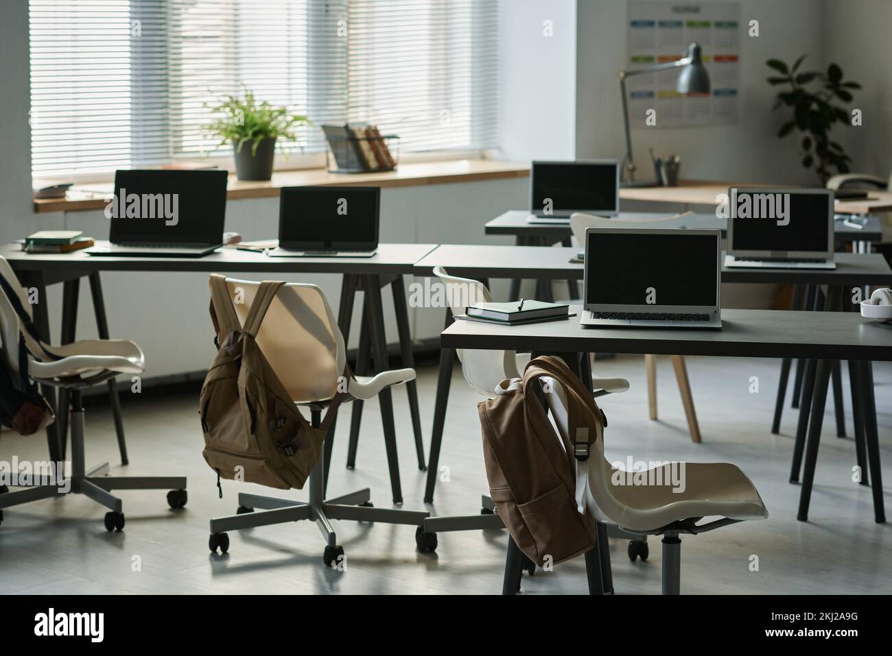 Modern empty classroom with computers on desks for IT lesson Stock Photo