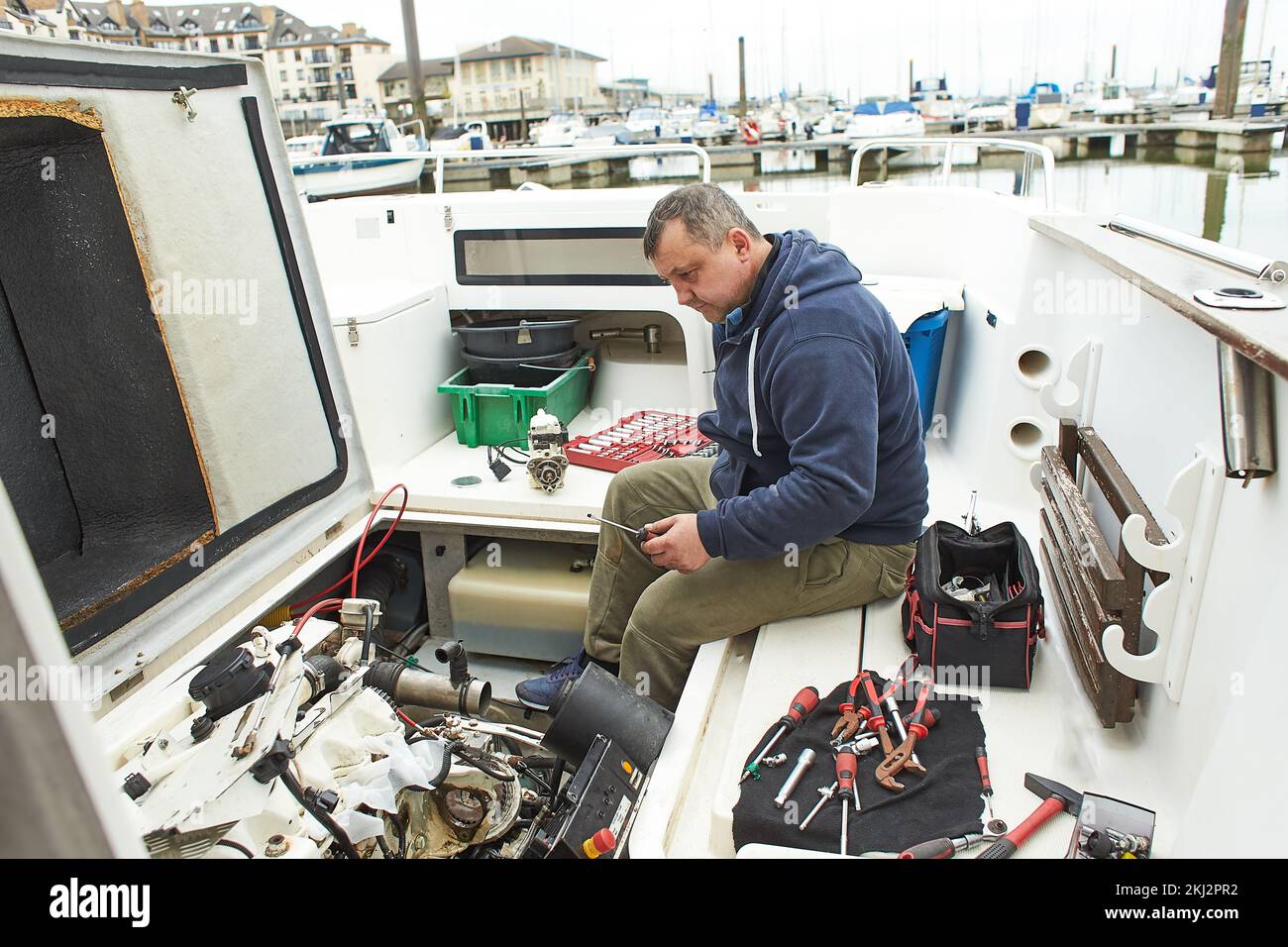 Boat mechanic repairing a ship engine Stock Photo Alamy