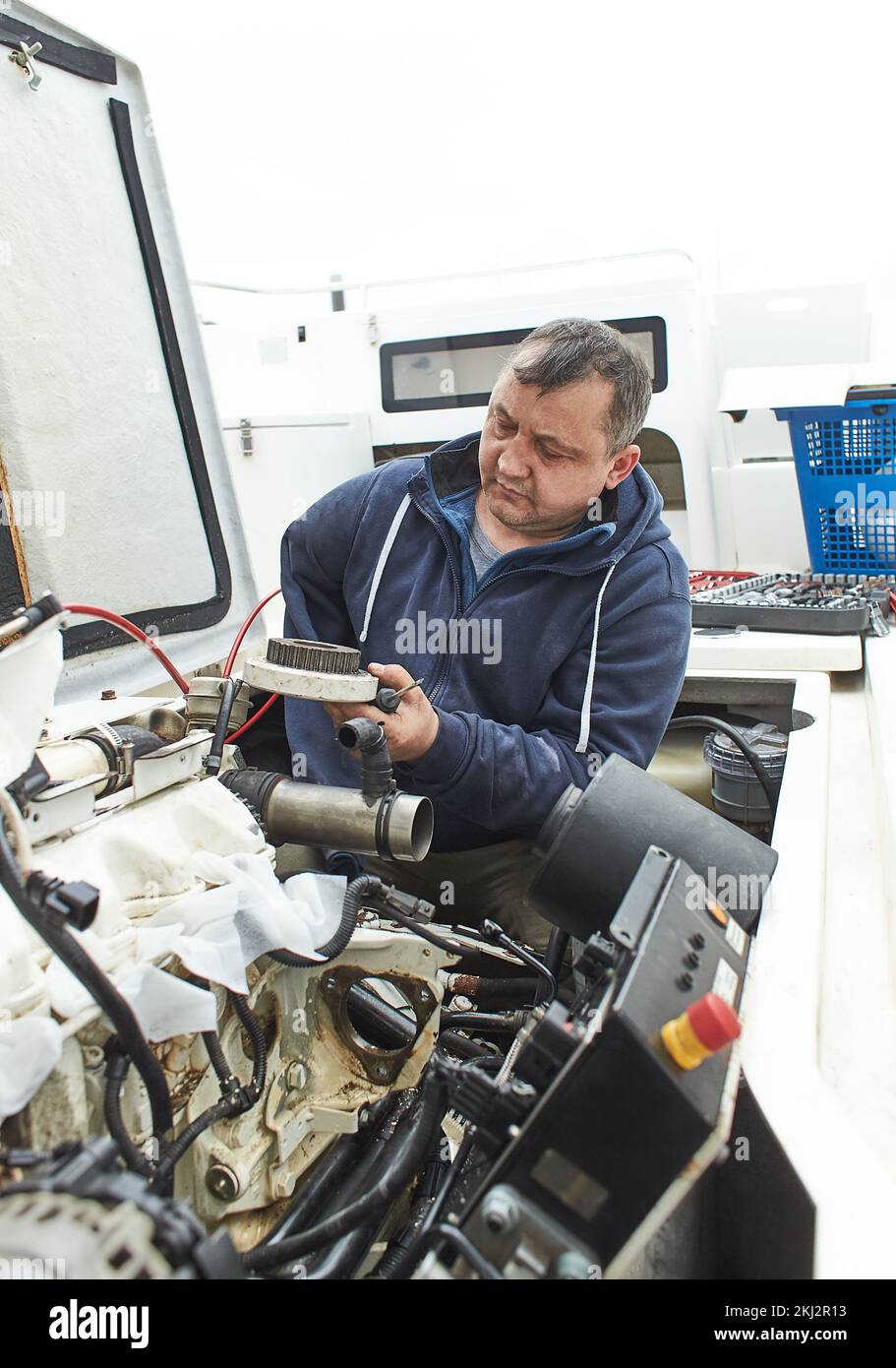 Boat mechanic repairing a ship engine Stock Photo Alamy