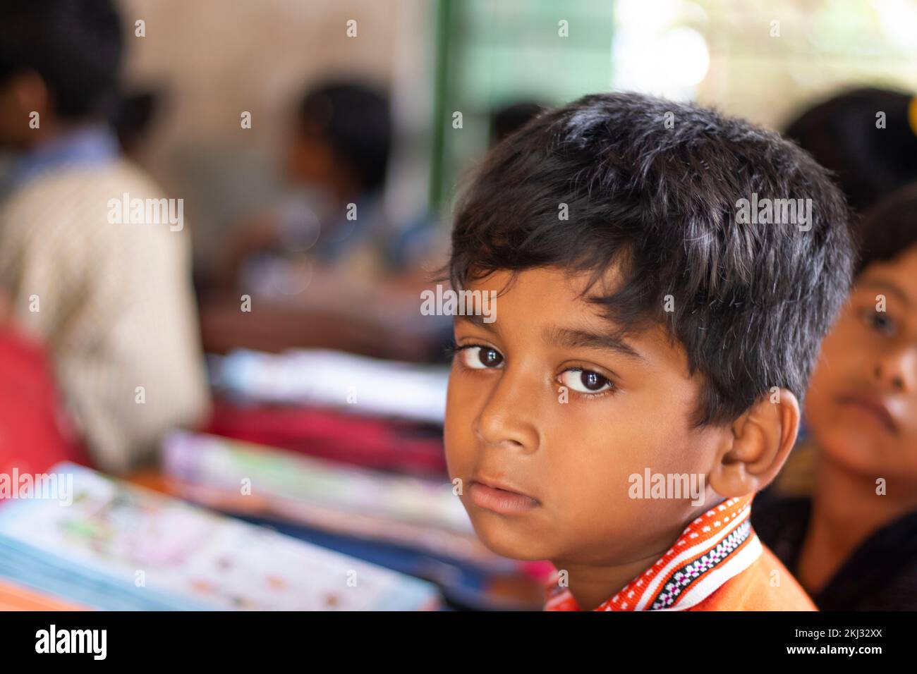 School boy looking at camera in classroom Stock Photo