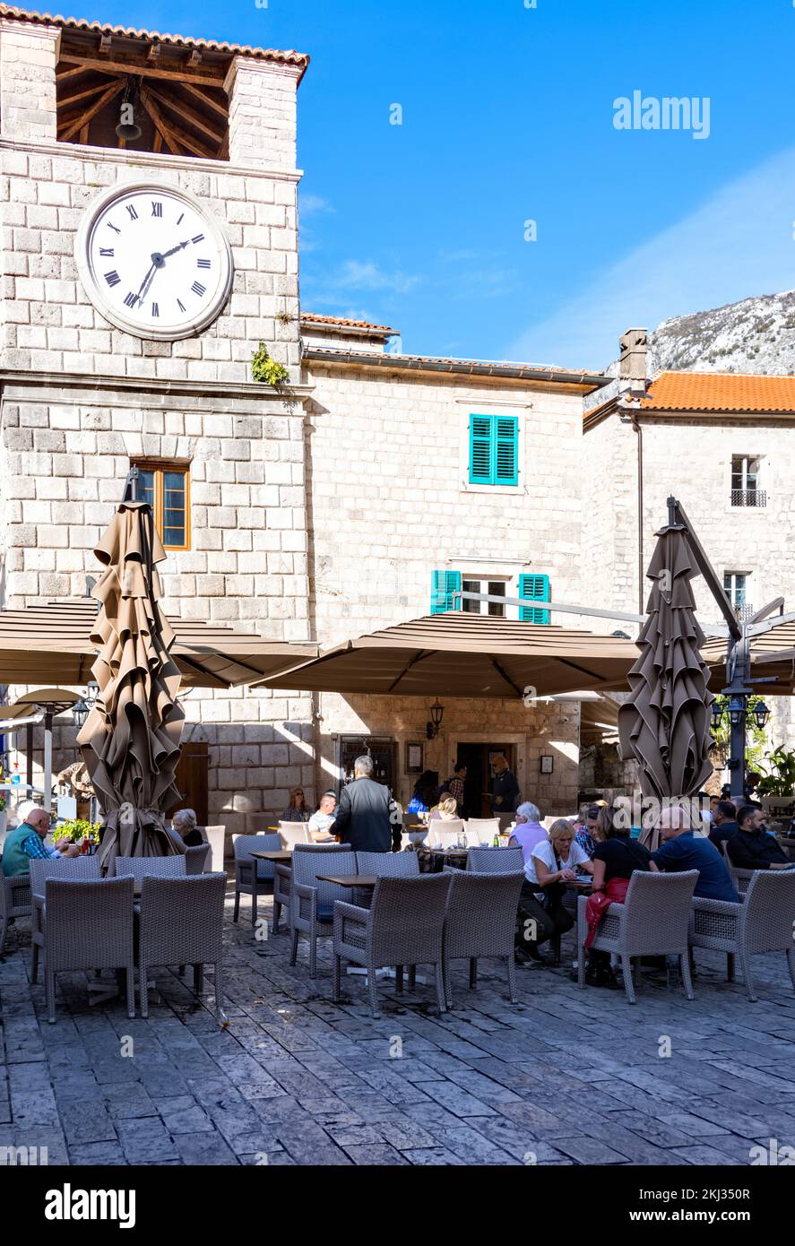 Clock tower and restaurants, Square of Arms, Kotor Old Town, Montenegro Stock Photo