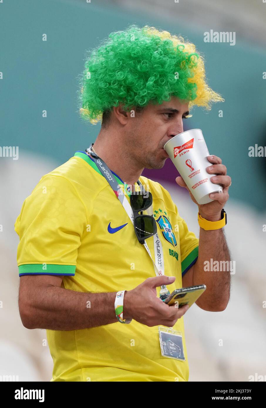 A fan of Brazil drinking a nonalcoholic Budweiser Zero beer, in the