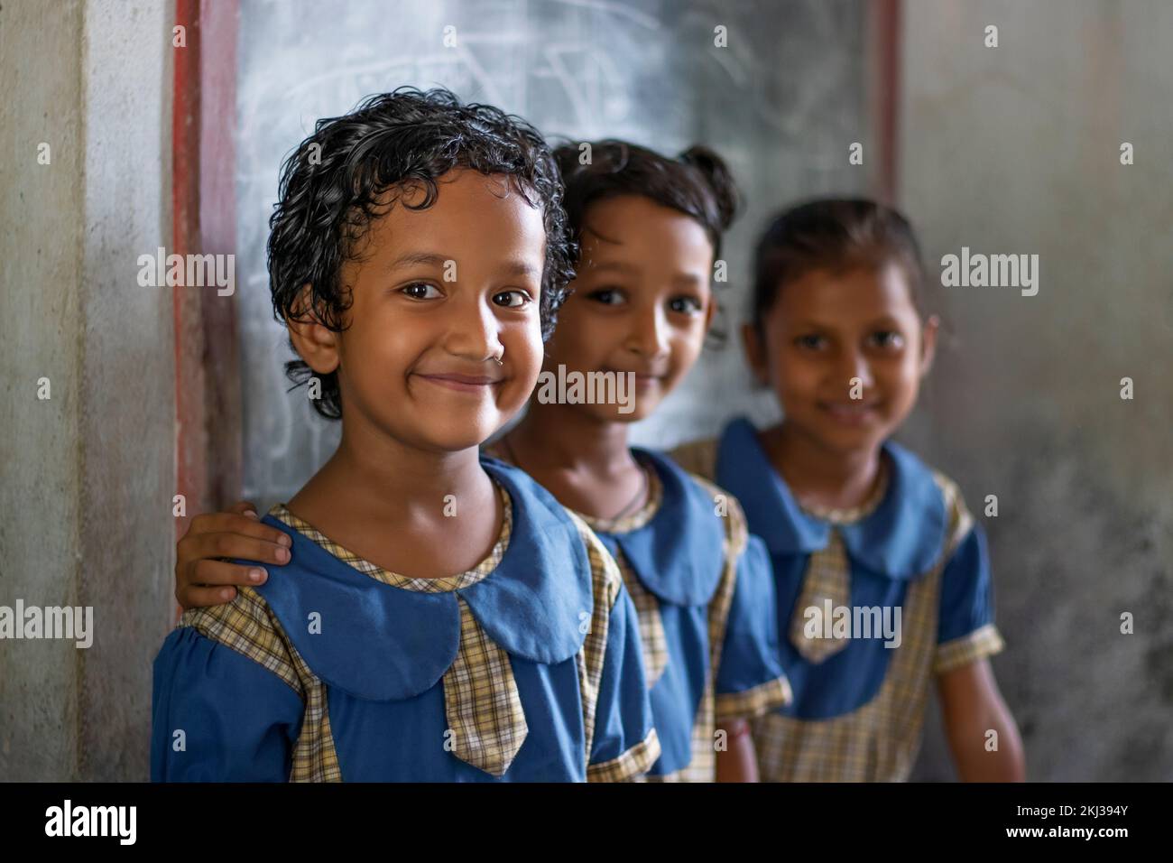 Three School Children's looking at camera at school Stock Photo