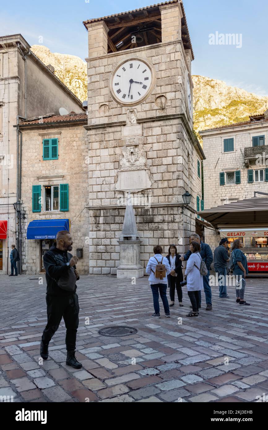 Clock tower and restaurants, Square of Arms, Kotor Old Town, Montenegro Stock Photo