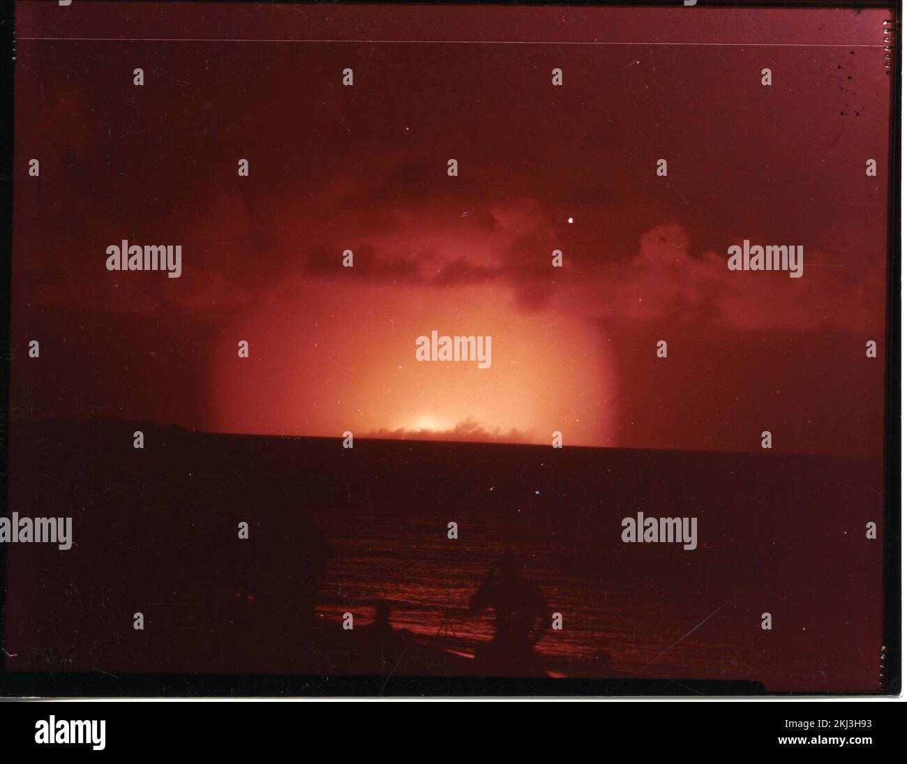 Project 24 - Operation Hardtack (Enewetak/Bikini/Johnnston Island Area) Detonation. SEQUOIA fireball, from Parry Island, observers in foreground. Photographs of Atmospheric Nuclear Testing at Pacific Island and Nevada Test Sites. Stock Photo