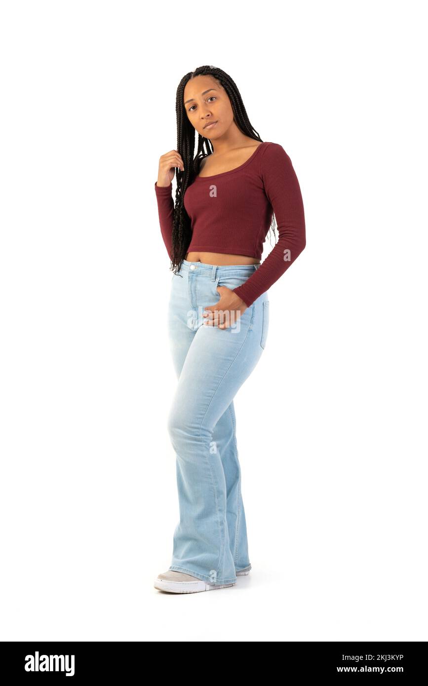 Young black woman with maroon shirt and jeans on a white background in studio Stock Photo