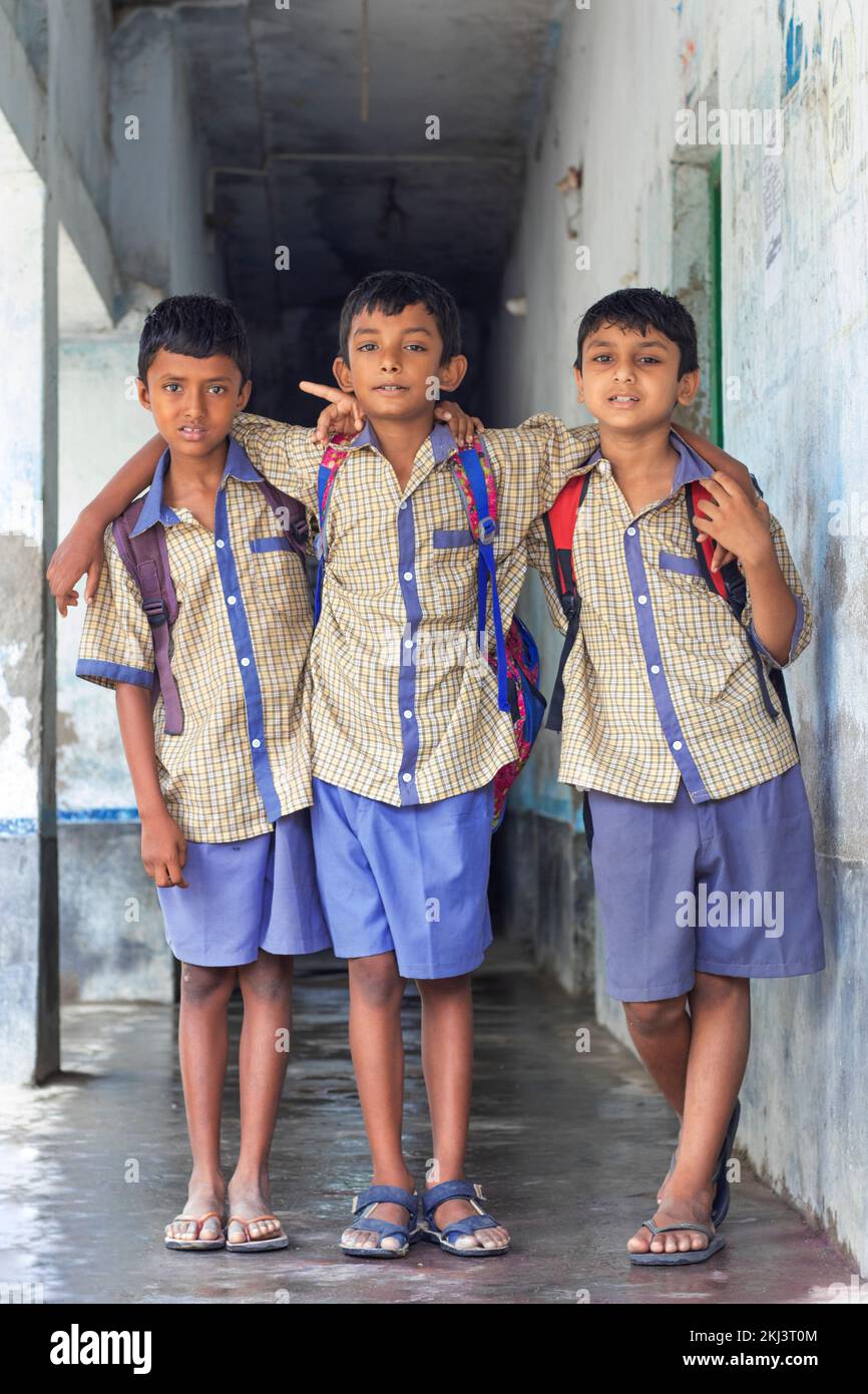Full length of Three school friends with backpack at school Stock Photo