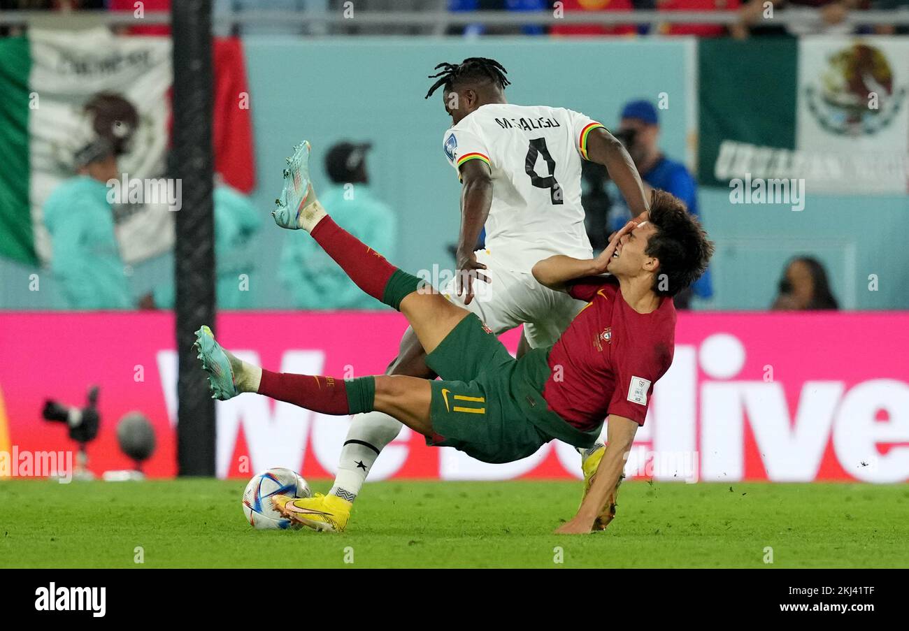 Portugal's Joao Felix is tackled by Ghana’s Mohammed Salisu during the FIFA World Cup Group H match at Stadium 974 in Doha, Qatar. Picture date: Thursday November 24, 2022. Stock Photo
