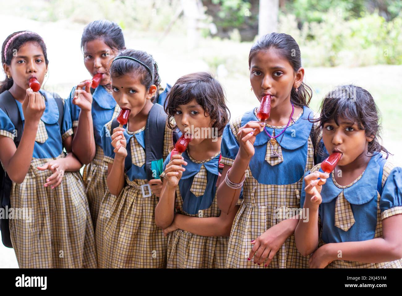School Children's  eating an ice lolly in outdoor Stock Photo