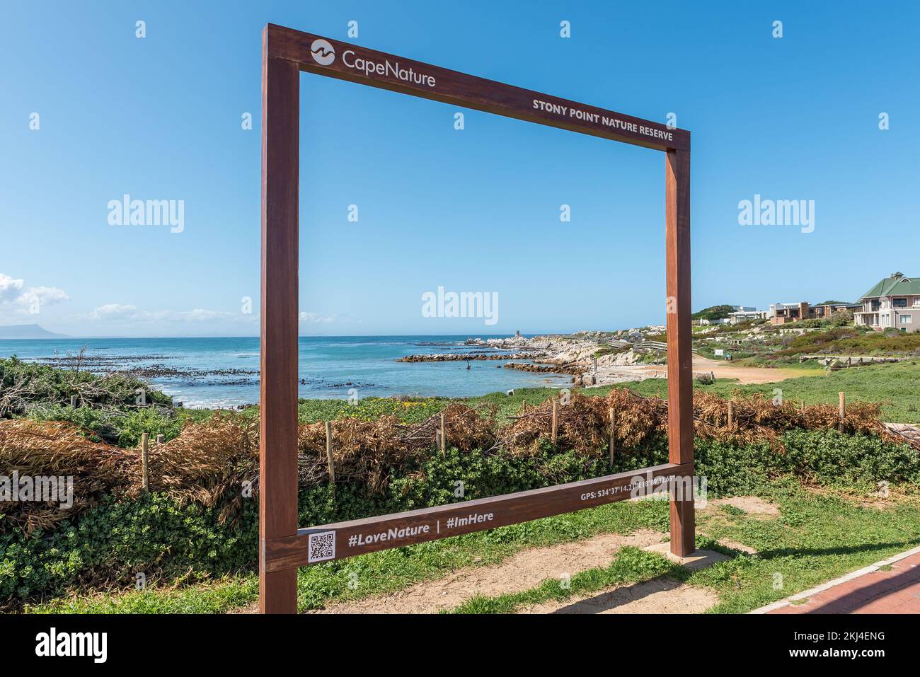Bettys Bay, South Africa - Sep 20, 2022: Stony Point Nature Reserve in Bettys Bay is visible through a giant selfie frame Stock Photo