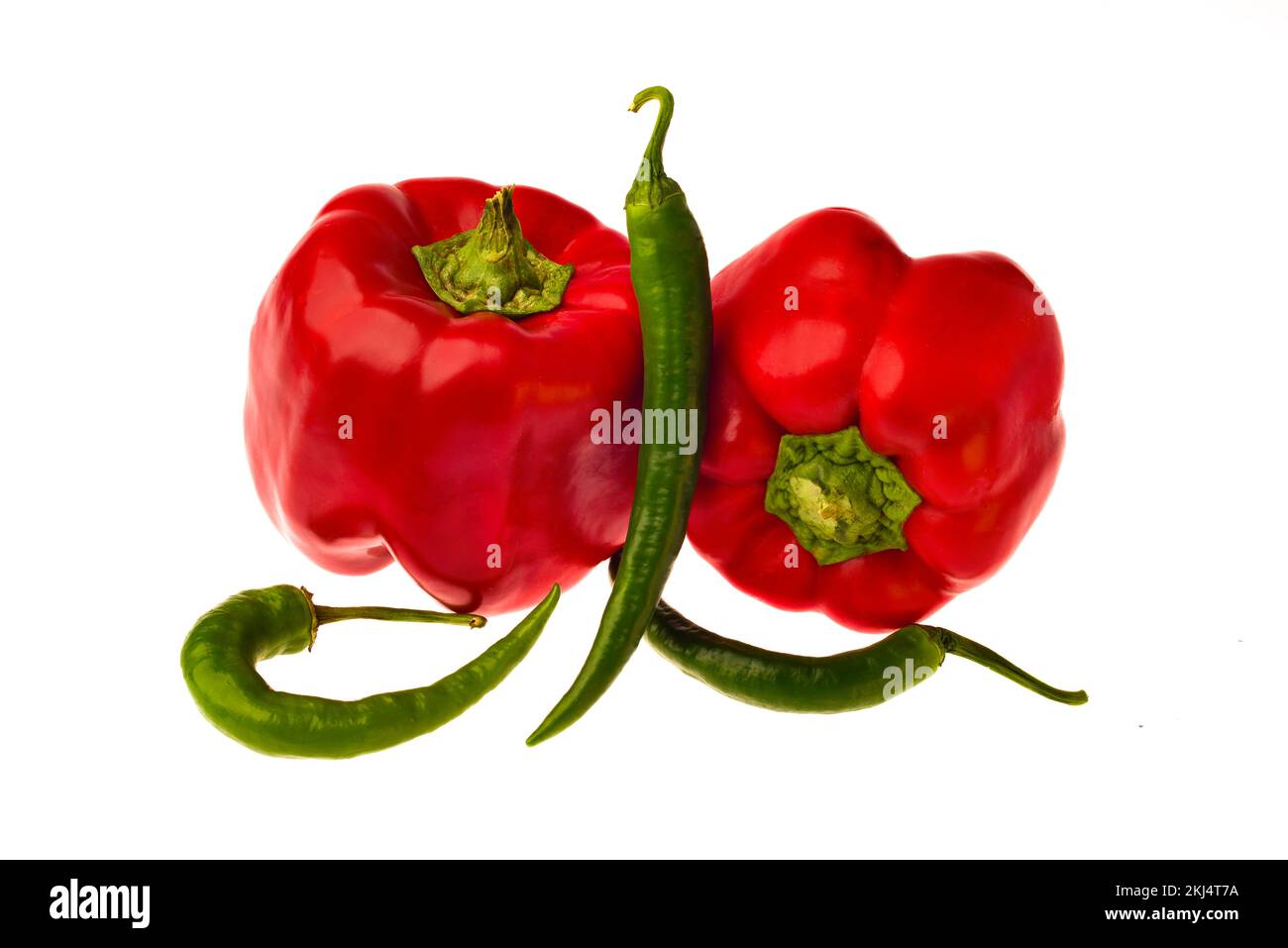 two red bell peppers and three green hot pepper on a white background
