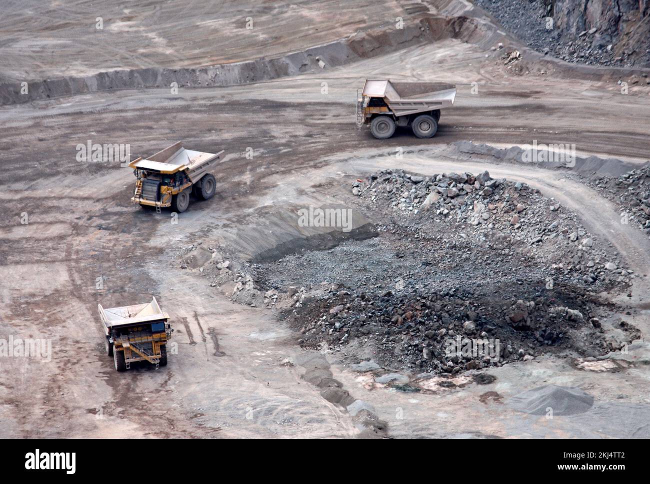 Three Large Lorries Working in a Stone Quarry. Stock Photo