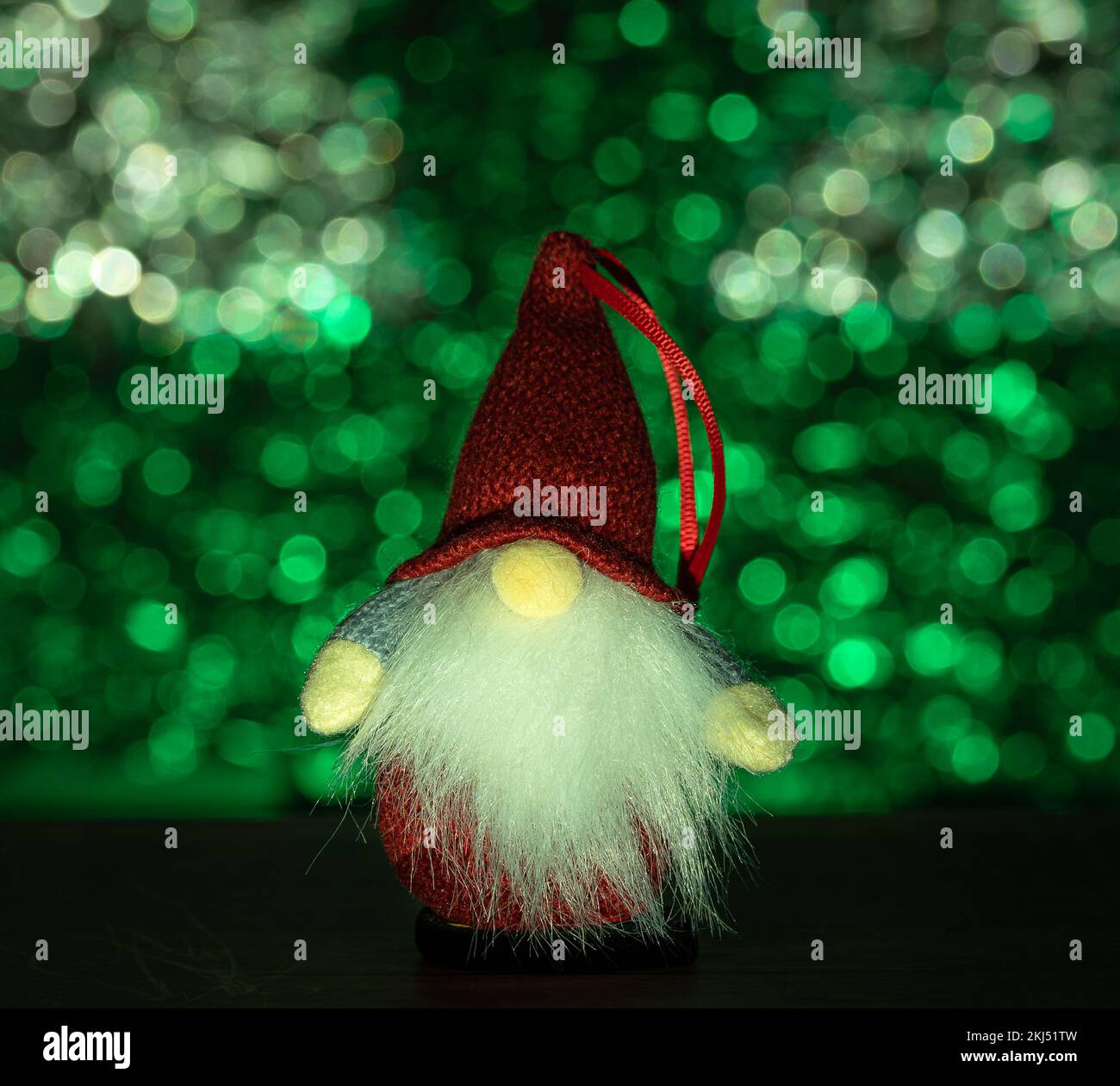 Scandinavian christmas gnome decoration in front of a green el bokeh