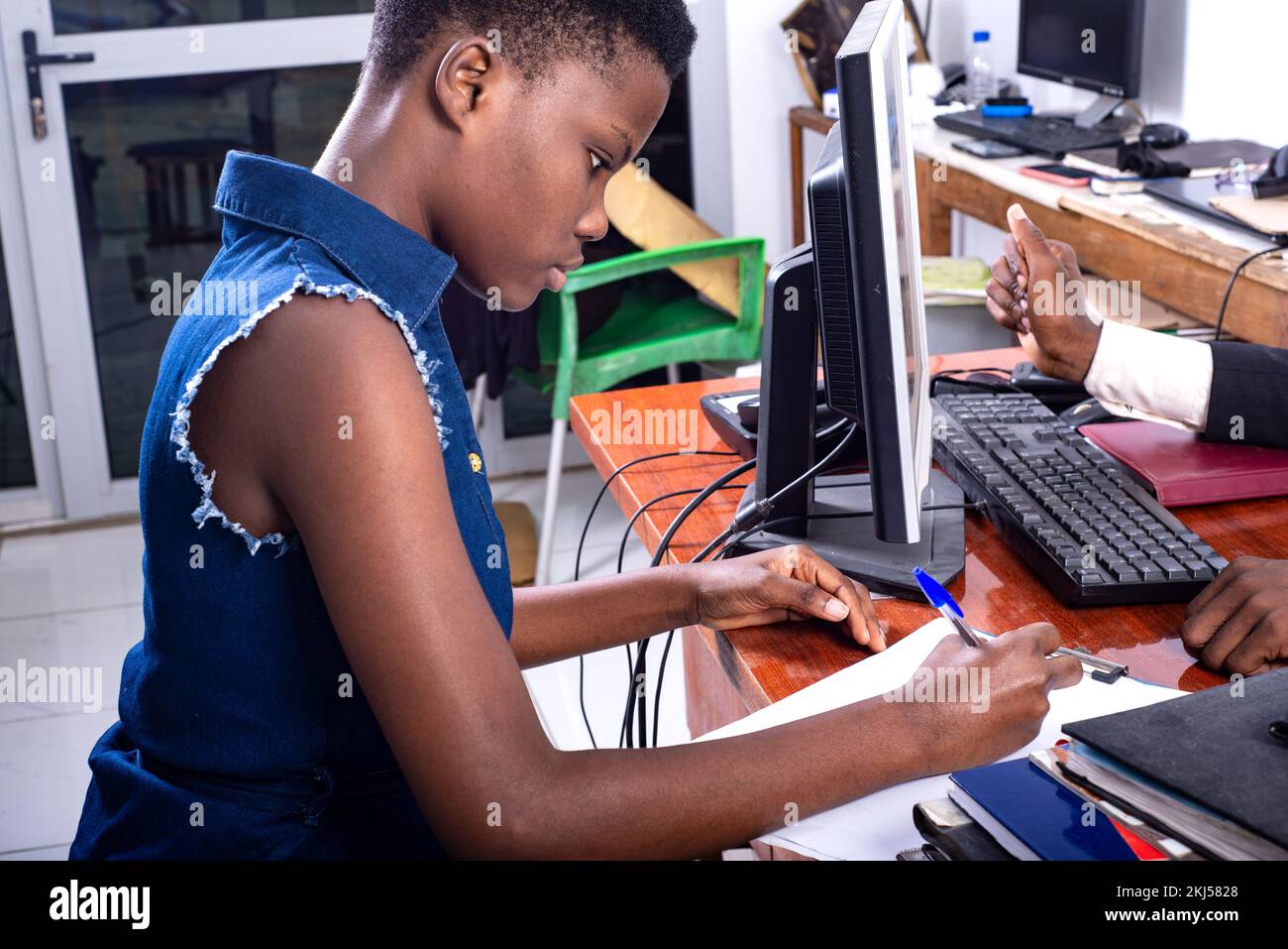 Girl signing document sitting hi-res stock photography and images - Alamy