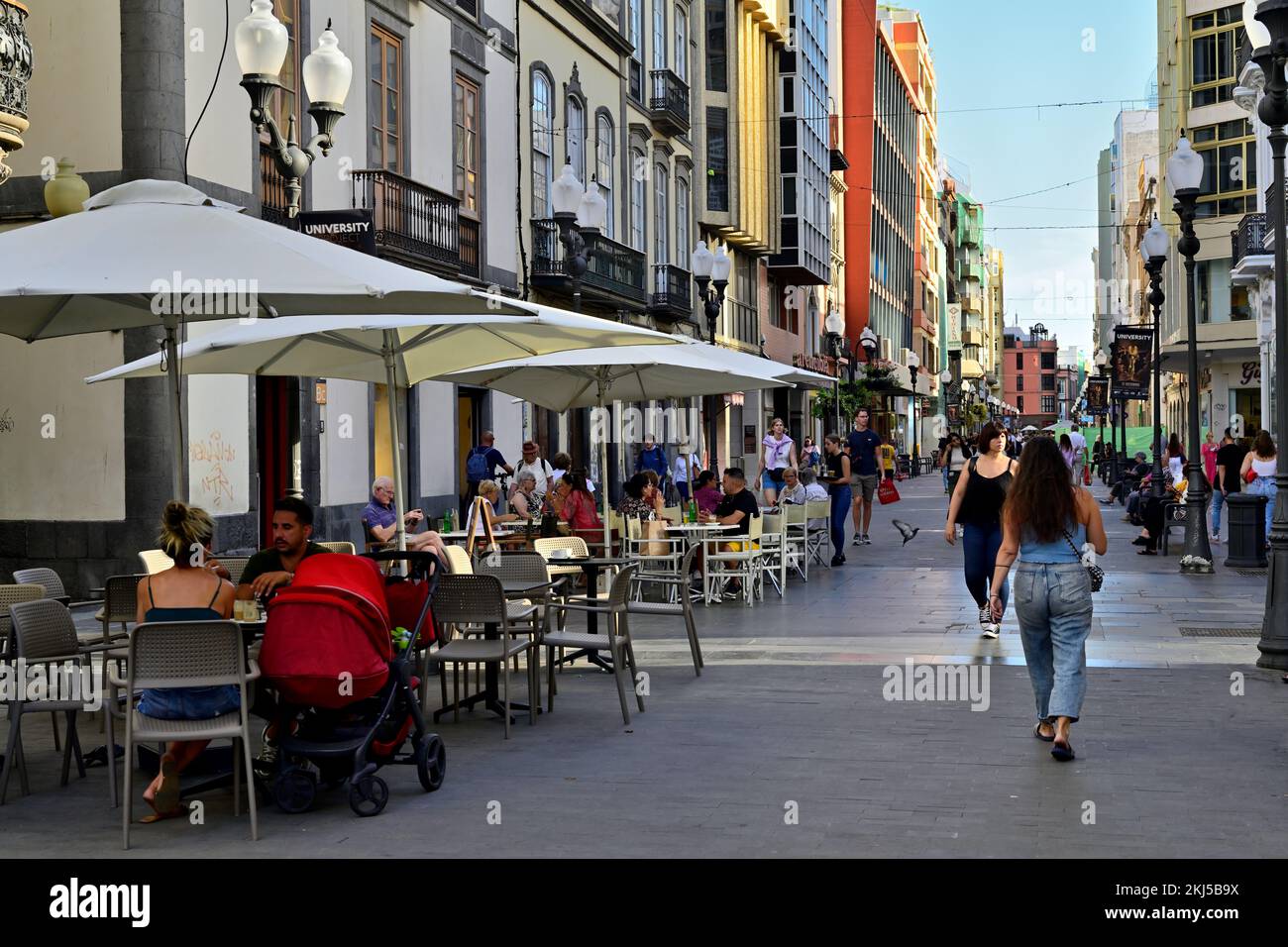 Sidewalk restaurants, cafes with people in pedestrianized shopping street of  Calle Triana, Las Palmas, Gran Canaria Stock Photo