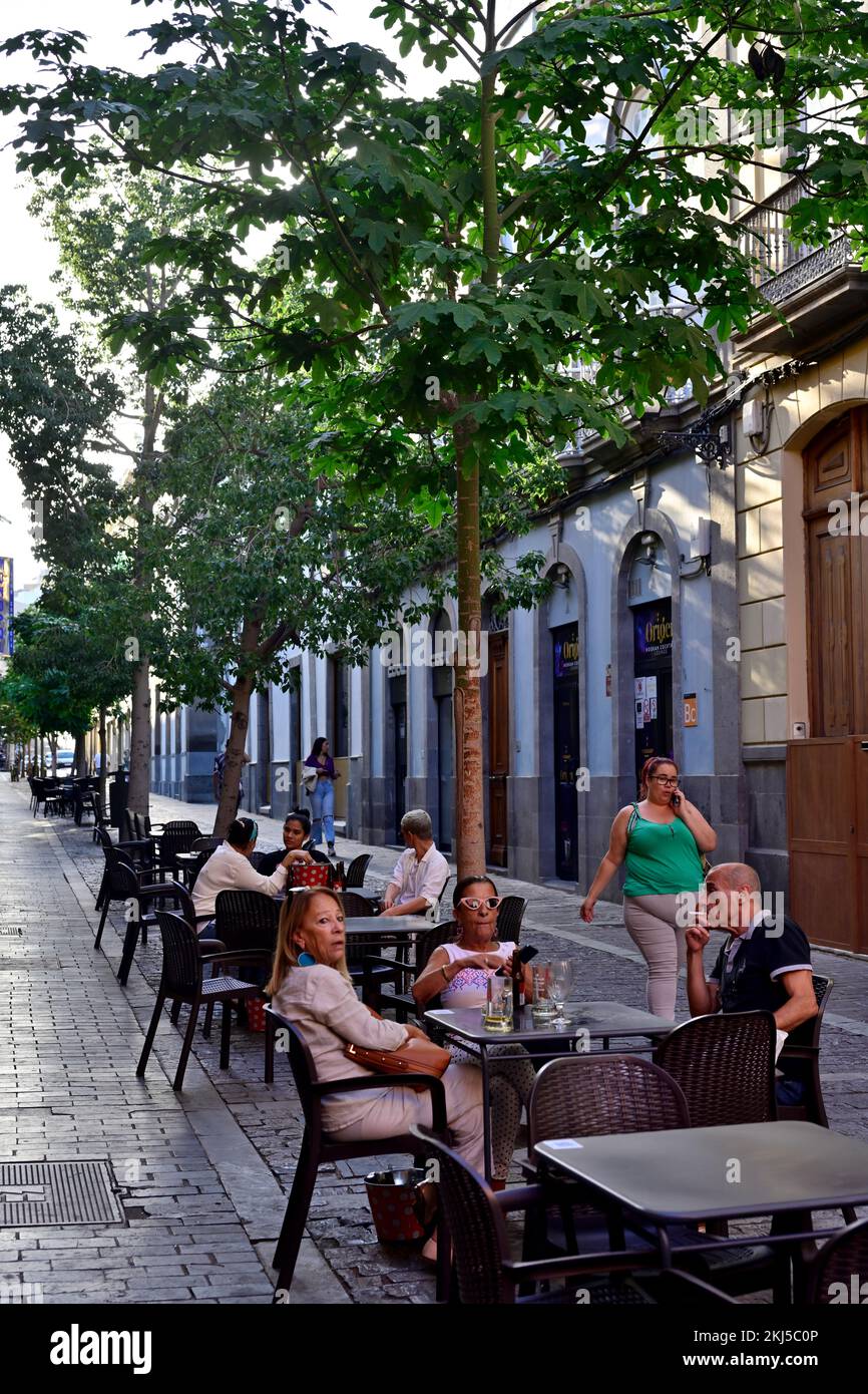 Sidewalk restaurants, cafes with people in pedestrianized shopping street of  Calle Triana, Las Palmas, Gran Canaria Stock Photo