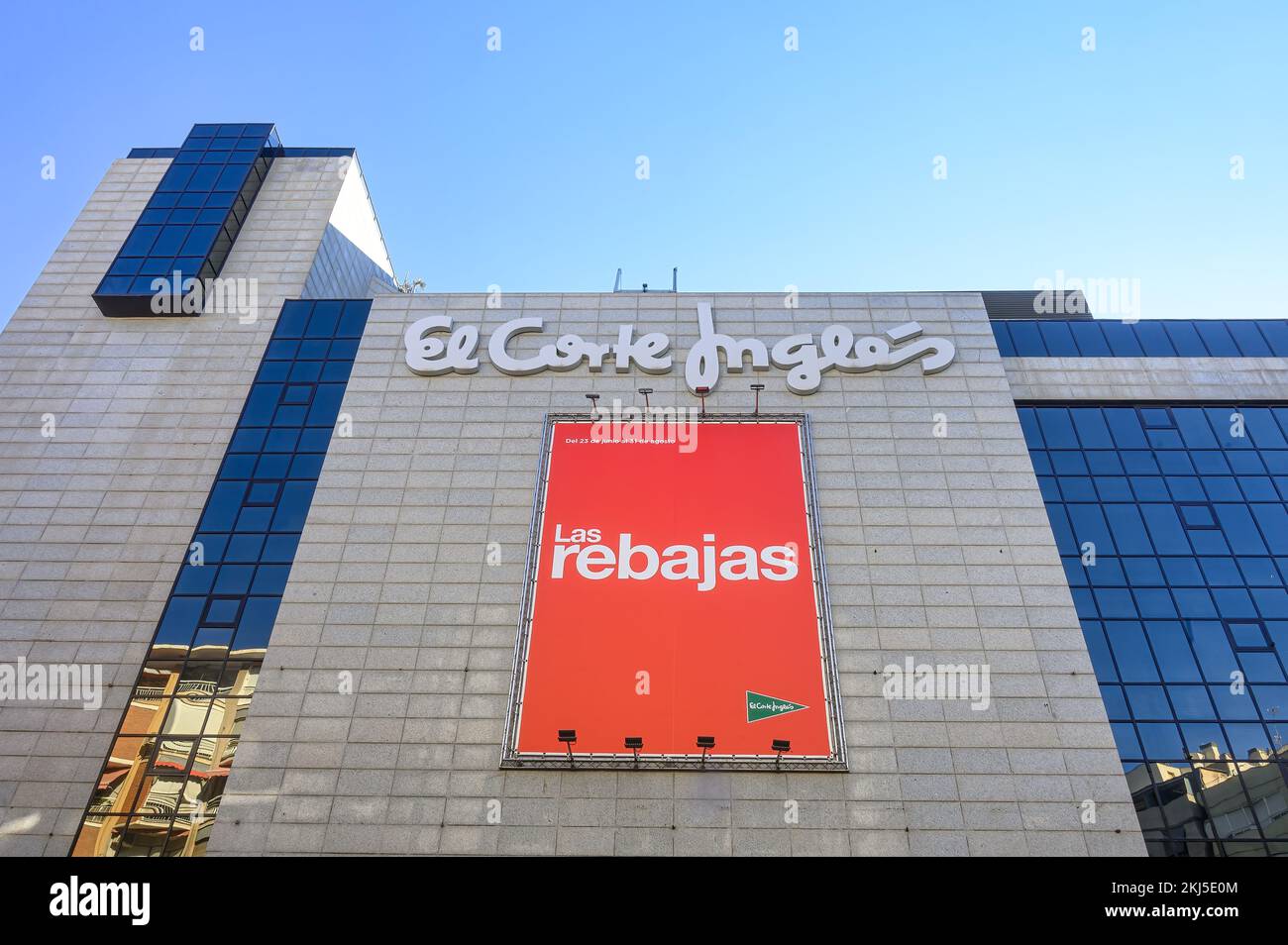 Alicante, Spain - September 12, 2022: Low-angle view of the facade of El Corte Ingles store. A sign written in white on a red background that says 'La Stock Photo