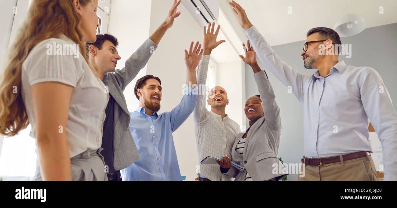 Team of happy joyful business people celebrating success and having fun in office Stock Photo