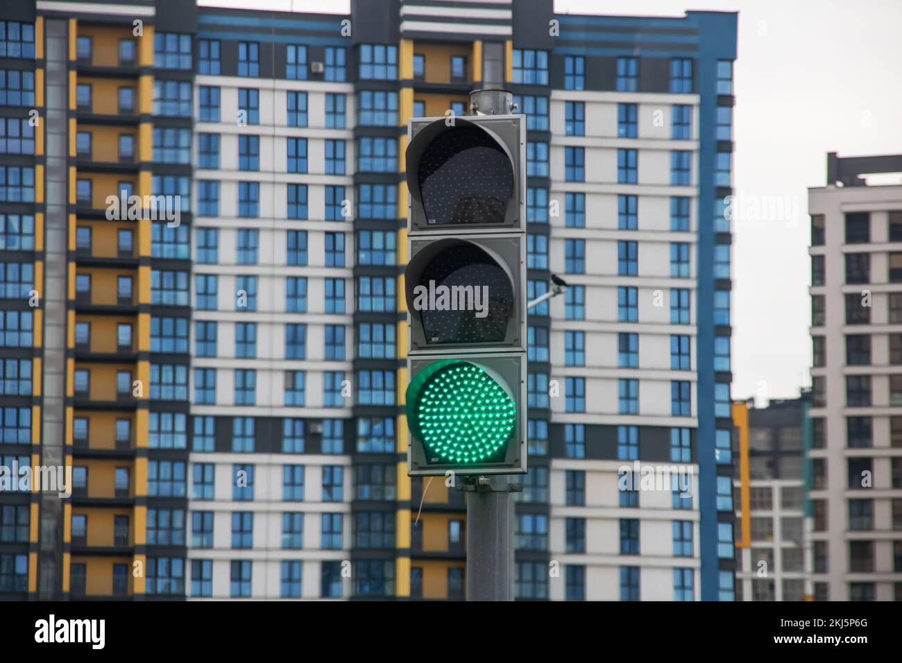 Green traffic light on the background of buildings close up Stock Photo ...