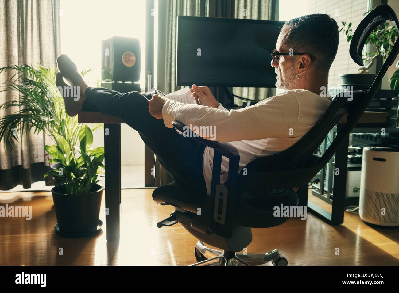 Man reading book at home. Stock Photo