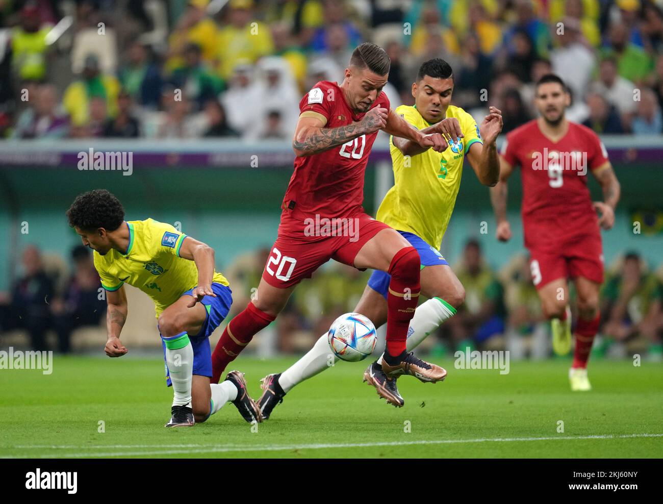 Serbia's Sergej Milinkovic-Savic (centre) gets past Brazil's Marquinhos (left) during the FIFA World Cup Group G match at the Lusail Stadium in Lusail, Qatar. Picture date: Thursday November 24, 2022. Stock Photo