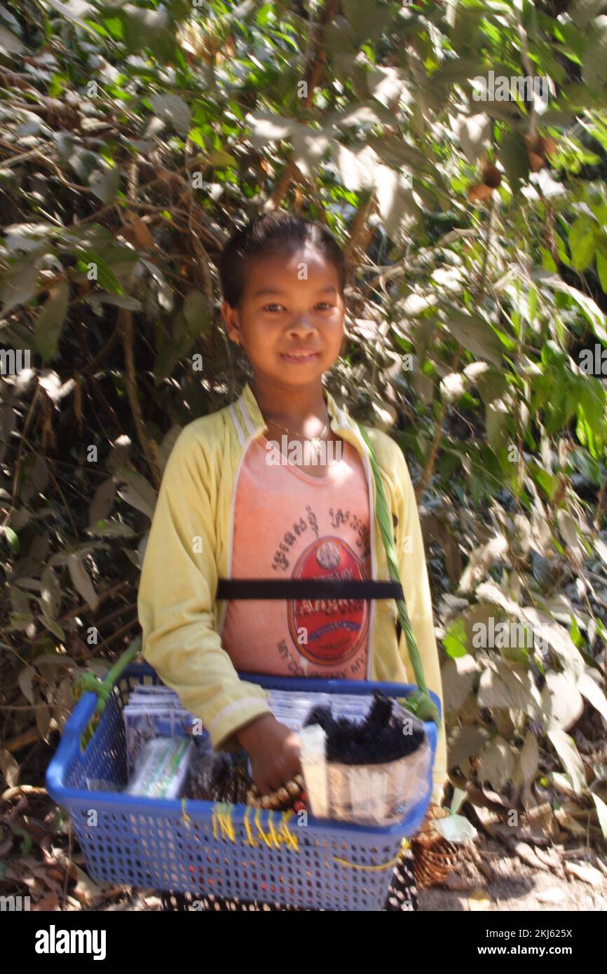 Young girl selling bangles, post cards and books, Preah Khan (Holy Sword) Temple, Siem Reap, Cambodia. Stock Photo