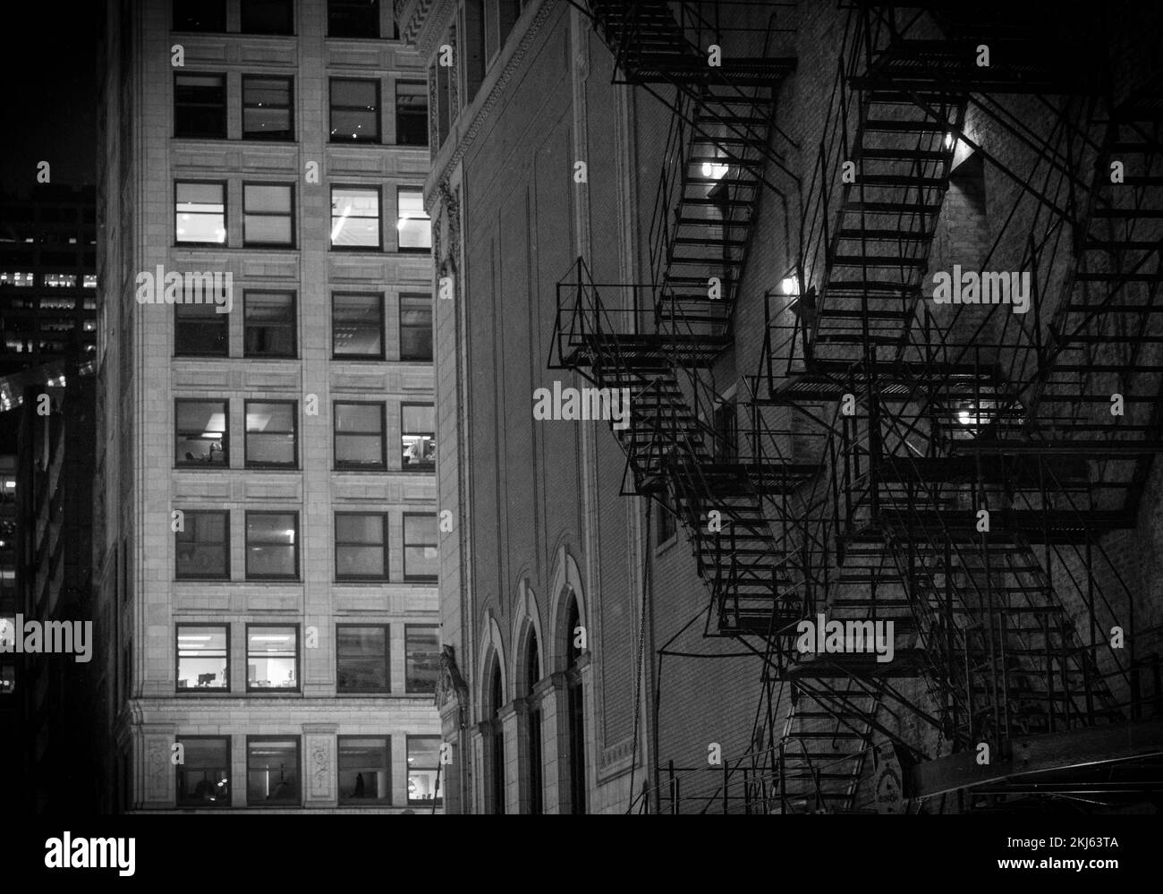 A grayscale of a fire escape of an apartment building Stock Photo