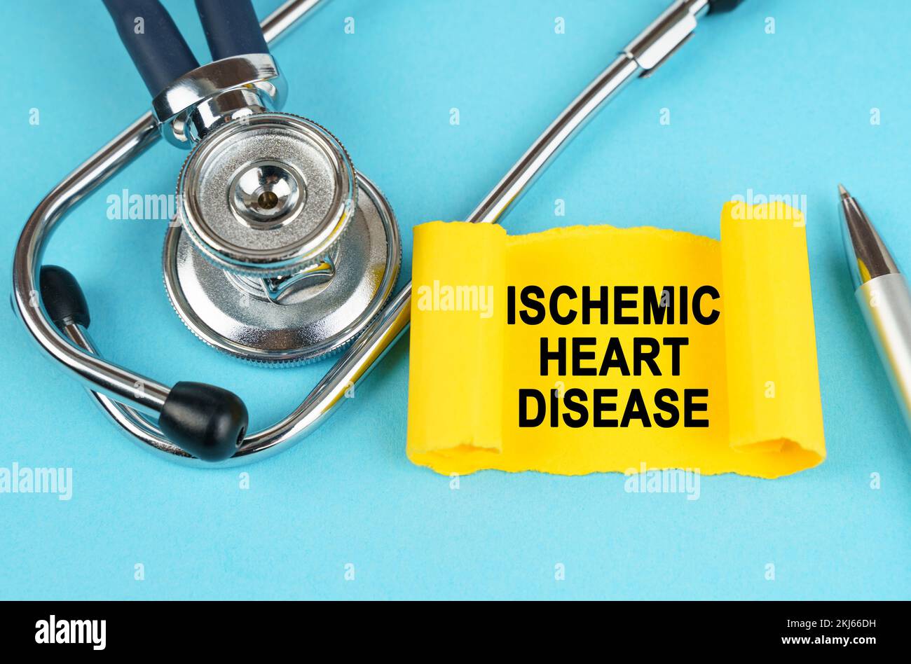 Medical concept. On the blue surface there is a stethoscope, a pen and a yellow sticker with the inscription - Ischemic Heart Disease Stock Photo