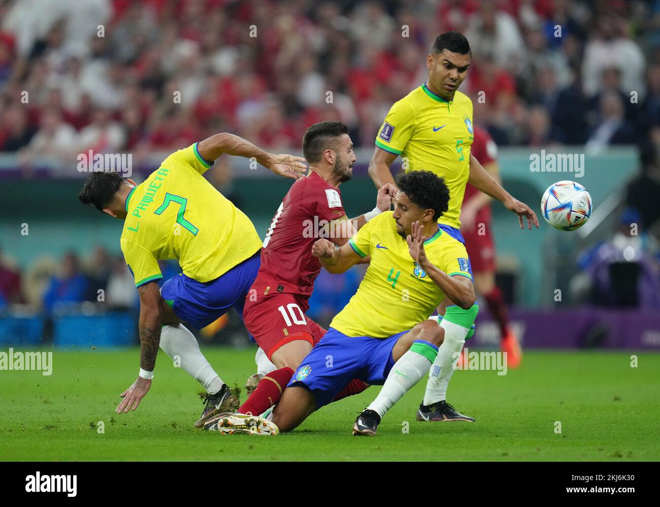 Serbia's Dusan Tadic (centre) battles with Brazil's Lucas Paqueta (left), Marquinhos (centre) and Casemiro during the FIFA World Cup Group G match at the Lusail Stadium in Lusail, Qatar. Picture date: Thursday November 24, 2022. Stock Photo