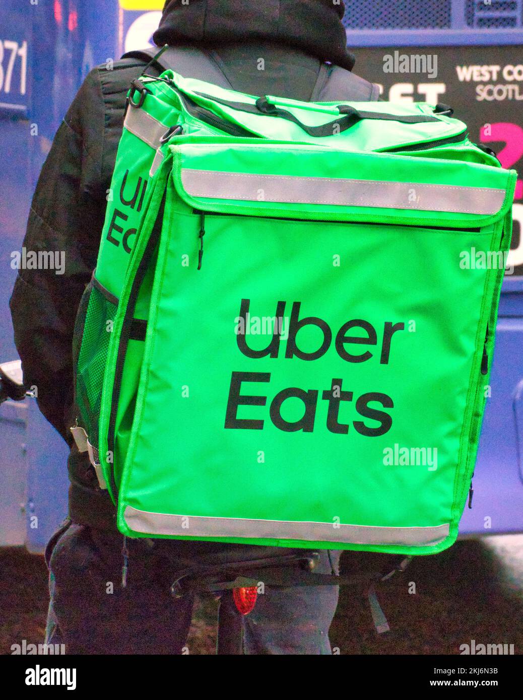 uber eats delivering food in traffic Stock Photo