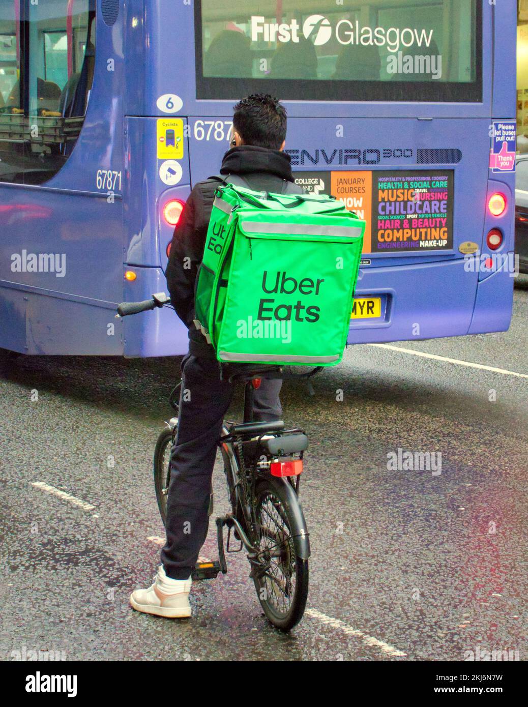 uber eats delivering food in traffic Stock Photo