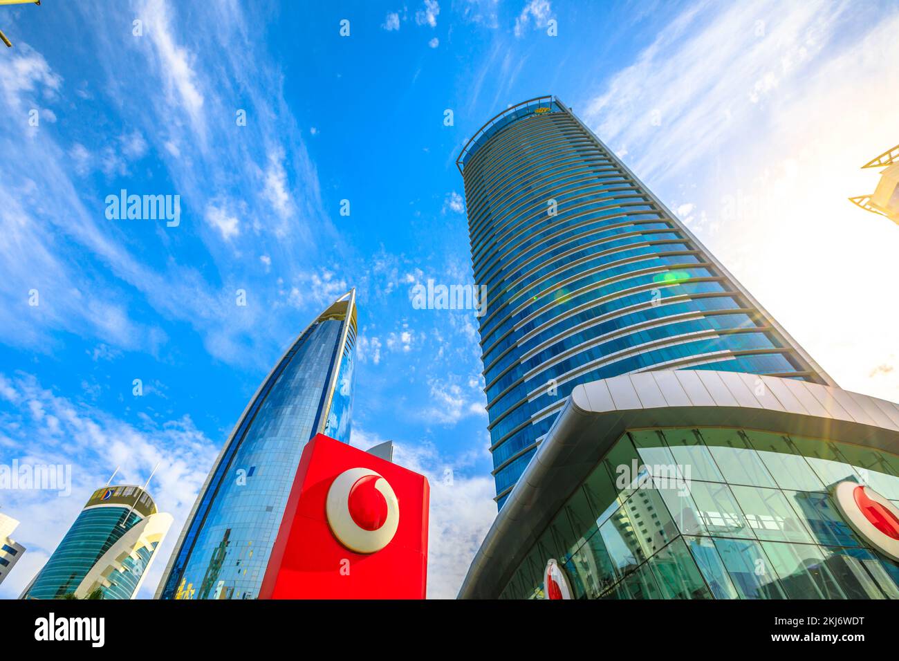 Doha, Qatar - February 17, 2019: bottom view of Vodafone Headquarters building and logo brand in Qatar West Bay area, Middle East. Vodafone is a multi Stock Photo