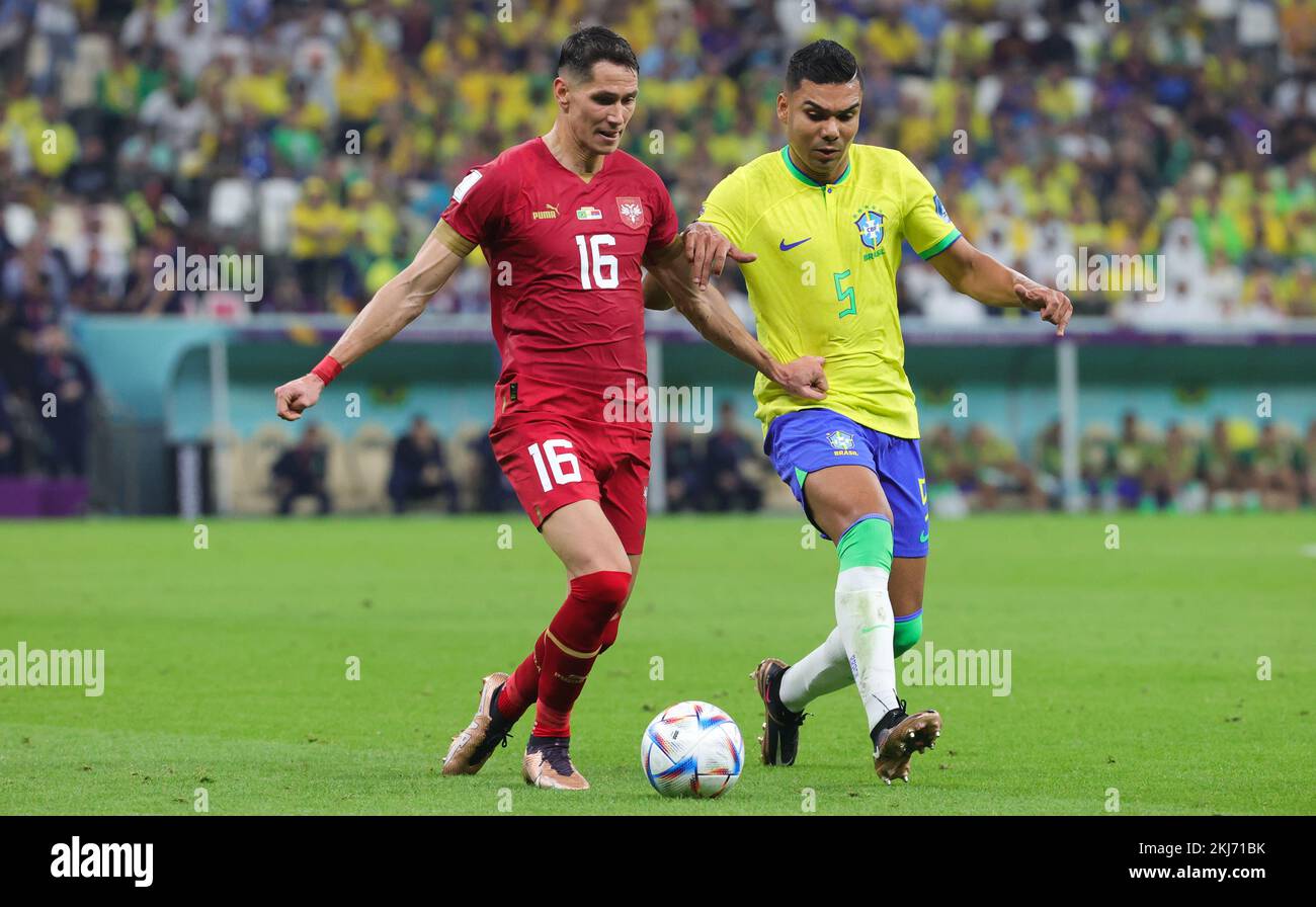 Serbian Sasa Lukic and Brazilian Casemiro fight for the ball during a soccer game between Brazil and Serbia, in Group G of the FIFA 2022 World Cup in Lusail, State of Qatar on Thursday 24 November 2022. BELGA PHOTO VIRGINIE LEFOUR Credit: Belga News Agency/Alamy Live News Stock Photo