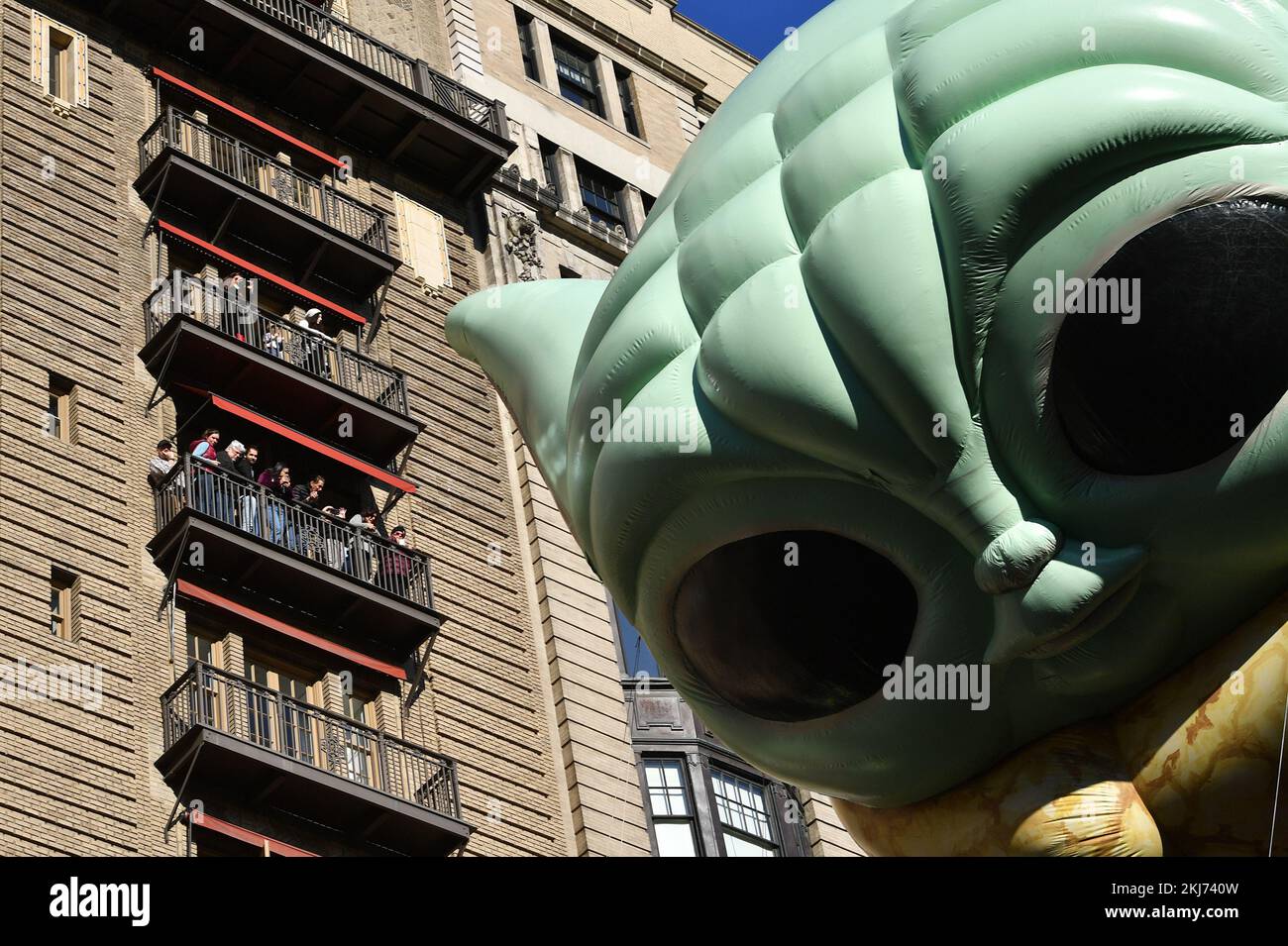 New York, USA. 24th Nov, 2022. People watch the Baby Yoda float from their balconies overlooking