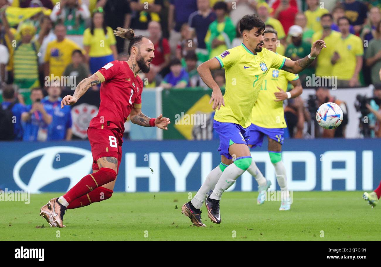 Serbian Nemanja Gudelj and Brazilian Lucas Paqueta fight for the ball during a soccer game between Brazil and Serbia, in Group G of the FIFA 2022 World Cup in Lusail, State of Qatar on Thursday 24 November 2022. BELGA PHOTO VIRGINIE LEFOUR Credit: Belga News Agency/Alamy Live News Stock Photo
