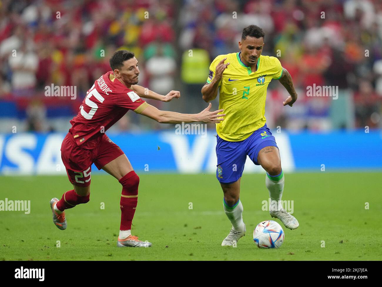 Serbia's Filip Mladenovic (left) and Brazil's Danilo in action during the FIFA World Cup Group G match at the Lusail Stadium in Lusail, Qatar. Picture date: Thursday November 24, 2022. Stock Photo