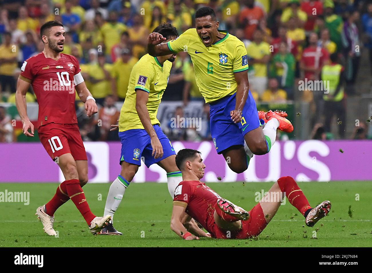Lusail, Qatar. 24th Nov, 2022. Alex Sandro (R) of Brazil competes with Sasa Lukic (Bottom) of Serbia during the Group G match between Brazil and Serbia at the 2022 FIFA World Cup at Lusail Stadium in Lusail, Qatar, Nov. 24, 2022. Credit: Chen Cheng/Xinhua/Alamy Live News Stock Photo