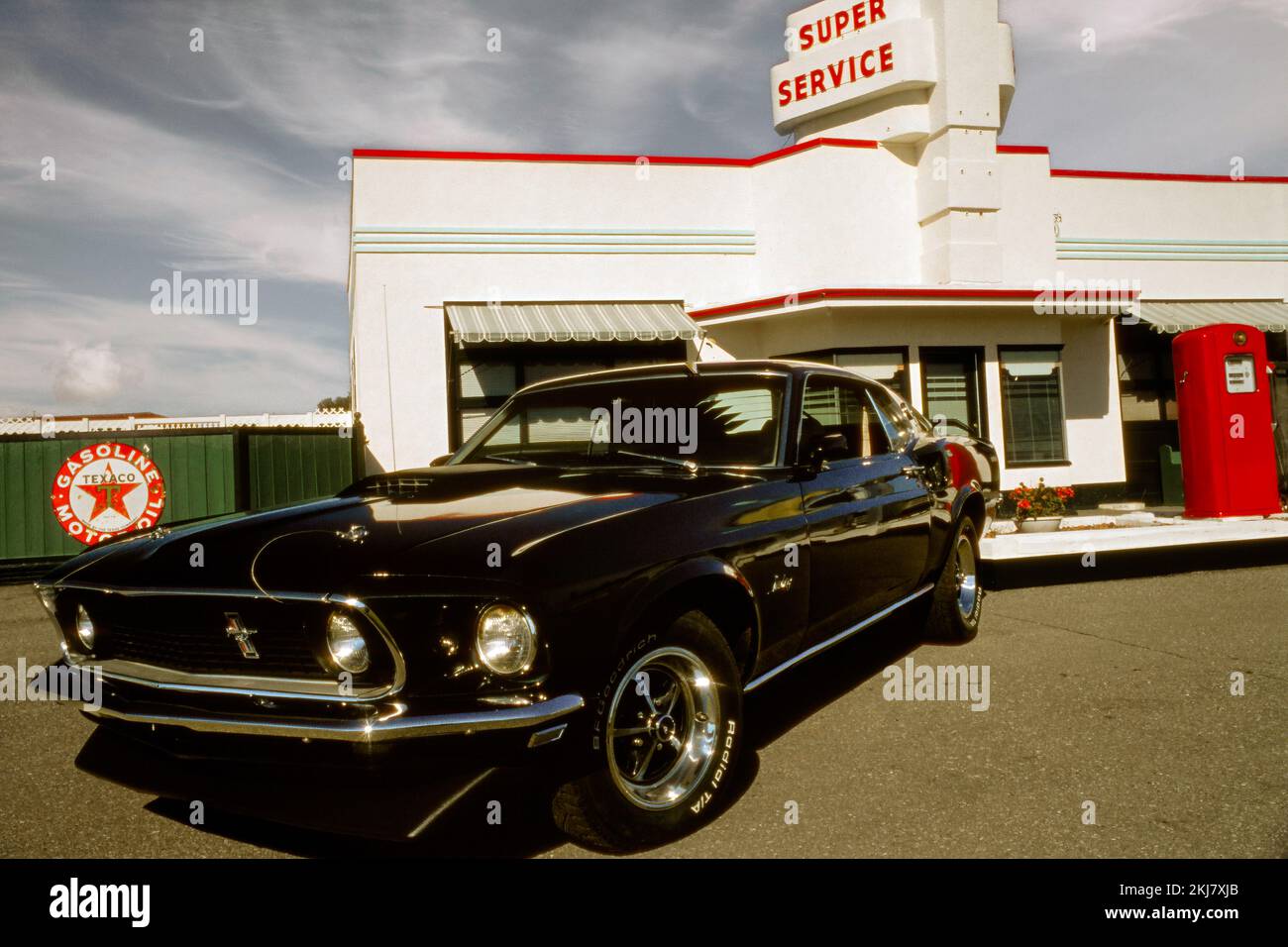 Vintage photograph of a 1969 Ford Mustang Fastback at a Texaco Service station Stock Photo