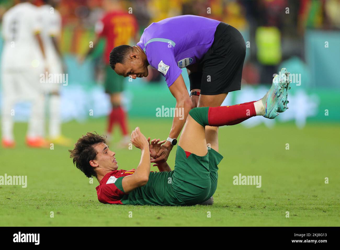 Doha, Qatar. 24th Nov, 2022. Joao Felix of Portugal reacts to a tackle and is helped up by the referee during the FIFA World Cup Qatar 2022 match between Portugal and Ghana at Stadium 974, Doha, Qatar on 24 November 2022. Photo by Peter Dovgan. Editorial use only, license required for commercial use. No use in betting, games or a single club/league/player publications. Credit: UK Sports Pics Ltd/Alamy Live News Stock Photo