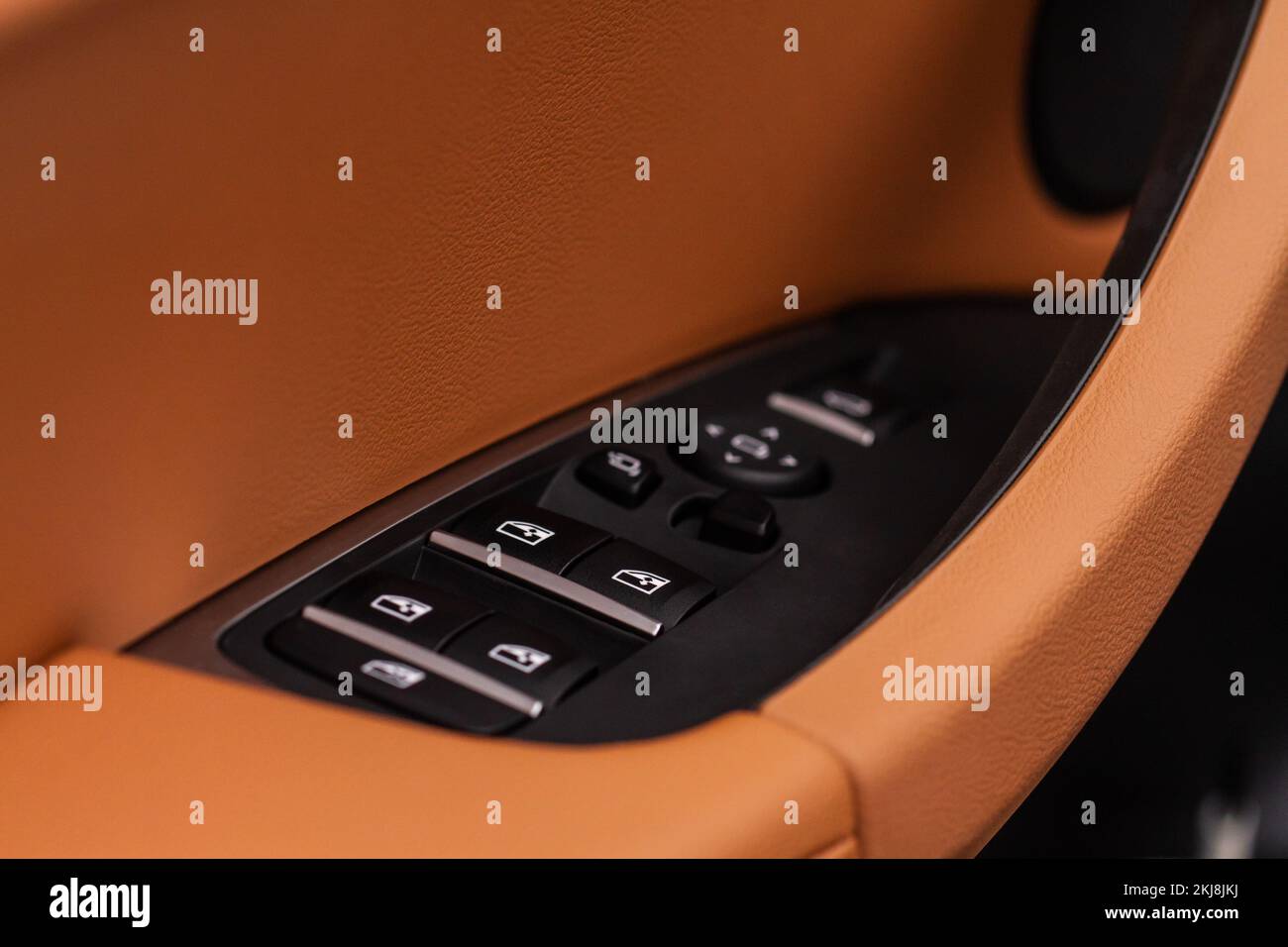 Close up view of button controlling window in modern car interior